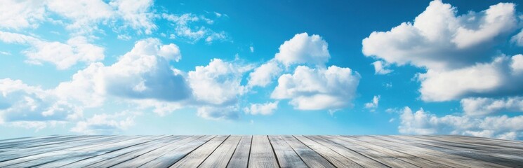 A stunning view of a bright blue sky filled with fluffy clouds over a wooden surface. This tranquil scene evokes feelings of peace and relaxation. Perfect for nature themes.