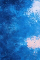 Obraz premium A textured background features a deep and vibrant blue hue, accented with splashes of white and pink