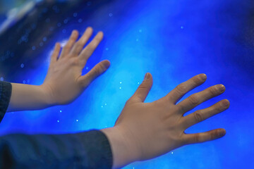 Exploring the Universe: Hands Touching a Vibrant Cosmic Background
