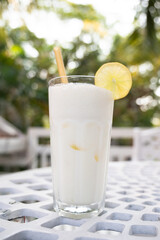 Lemon ginger lassi on a table, refreshment in India, cold milk yogurt drink, traditional indian smoothie