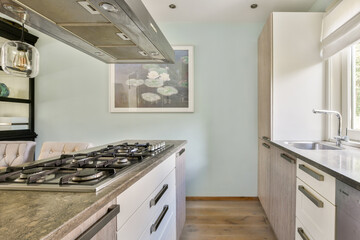A stylish modern kitchen featuring minimalistic cabinets, polished countertops, and contemporary...