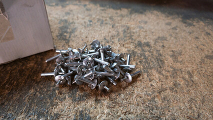 Blind rivets on a table in the workshop or warehouse