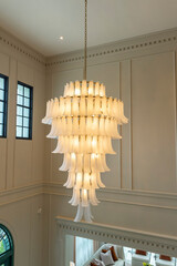 An elaborate, crystal chandelier in a hotel lobby or luxury home.
