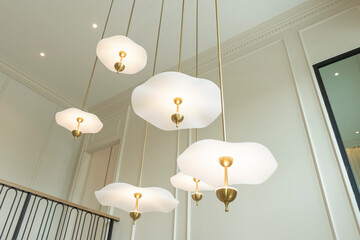 Home entrance hallway with modern chandelier and stairway leading to second floor.
