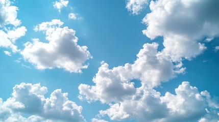 A stunning view of fluffy white clouds against a bright blue sky, capturing the beauty of nature and the serenity of the open air.