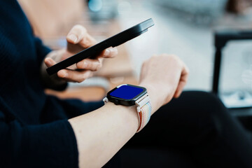 Modern Technology: A Close-Up of a Smartwatch and Smartphone Interaction