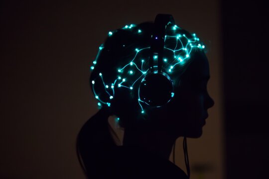 Futuristic silhouette of person with sleek brain computer interface headset