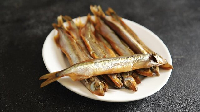 Fish smoked capelin sprat  dish fresh delicious gourmet food background on table rustic food top view copy space pescetarian diet