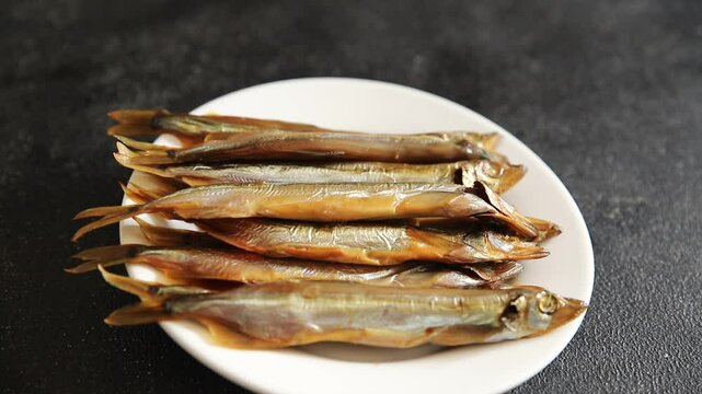 Fish smoked capelin sprat  dish fresh delicious gourmet food background on table rustic food top view copy space pescetarian diet