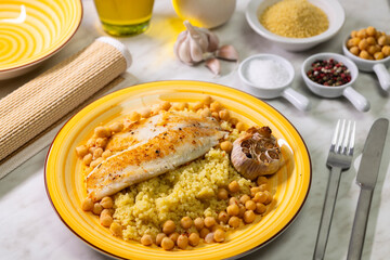 grilled cod with couscous, chicken pea and baked garlic