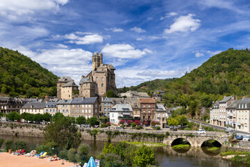 Estaing castle dominating the village on the banks of lot river in aveyron, france