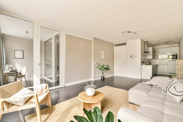A beautifully designed modern interior featuring a cozy seating area, contemporary furnishings, and...