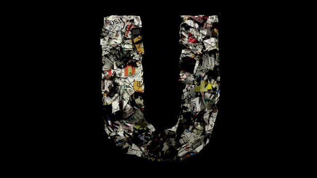 letter U with cut up newspaper isolated on black 