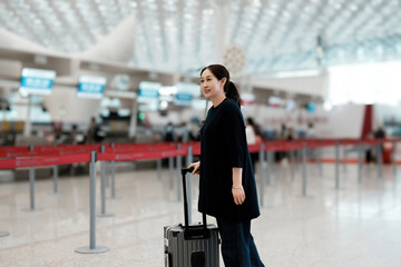Woman Traveling at Modern Airport with Stylish Luggage