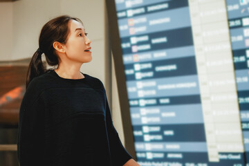 Traveler Engaging with Departure Information at Modern Airport Terminal