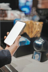 Engaging with Technology: A Hand Holding a Smartphone in a Modern Setting