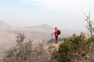 Obraz premium A backpacker is watching nature. Sports, nature, traveler