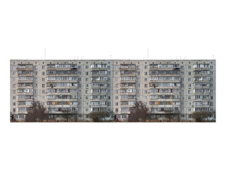 Nine-storey panel apartment building with enclosed balconies is isolated.