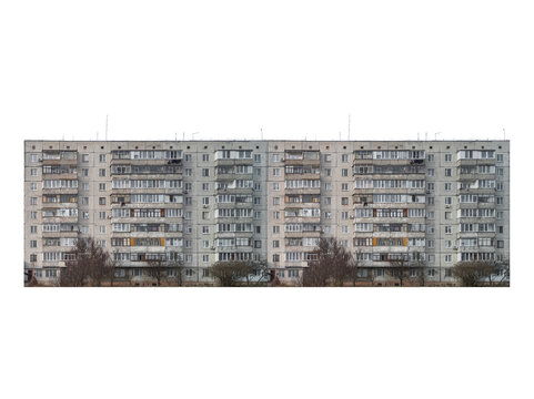 Nine-storey panel apartment building with enclosed balconies is isolated.