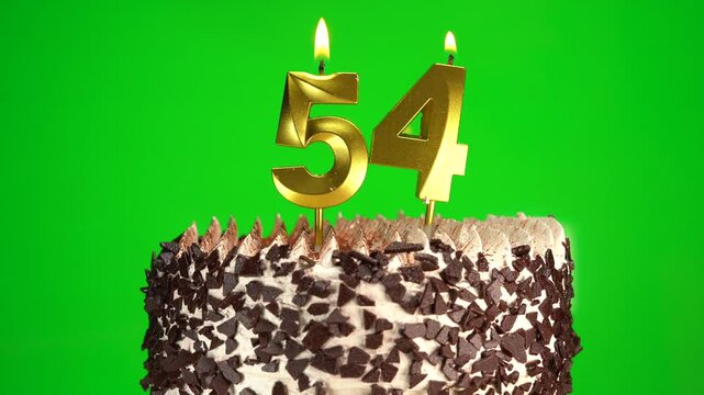 Burning candles number 54 on birthday cake against chroma key background. Fifty-fourth birthday. Birthday celebration