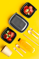 Takeaway food - tomatoes salad in catering boxes, top view. Food delivery concept.