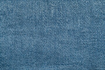 Naklejka premium Close-up view of denim fabric highlighting intricate weave patterns and textures for fashion enthusiasts
