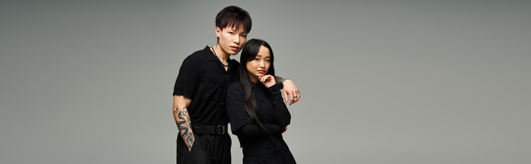 Stylish couple showcasing love and romance in contemporary fashion against a minimalist backdrop