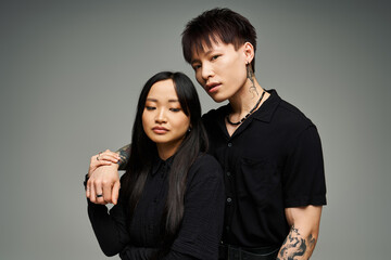 Stylish couple embraces in a romantic portrait showcasing modern fashion and deep connection