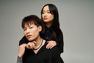 Stylish couple expressing love and connection against a minimalist backdrop in a creative setting