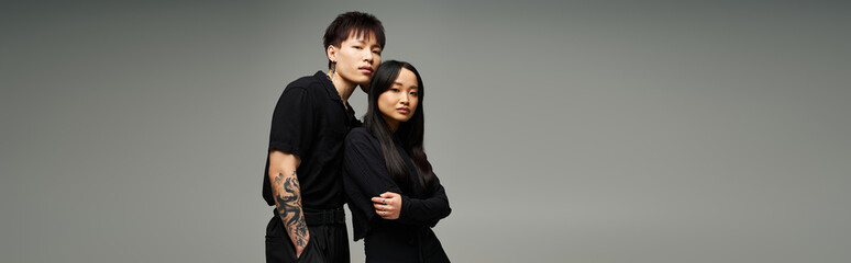 Stylish couple exudes love and romance in fashionable poses during modern studio shoot