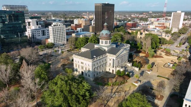 Departing aerial footage of the SC statehouse with Columbia, SC in the background.