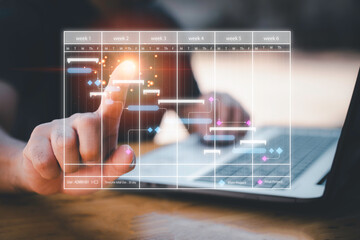 Scheduling activities with a planning software, Corporate strategy for finance, operations, sales, marketing. Project manager working with Gantt chart schedule to plan tasks and deliverables.