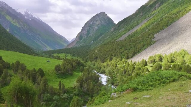 Drone footage captures mountainous landscapes of either Ala Archa National Park or Alamedin Gorge, famous for outdoor activities and scenic nature in Kyrgyzstan.