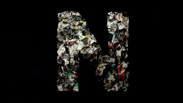 Letter N with cut up newspaper isolated on black 