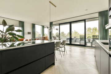 A sleek and contemporary kitchen featuring elegant furniture, large windows, and stylish decor, creating a bright and inviting atmosphere.