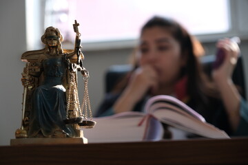 A woman lawyer is performing her professional duties in her office.