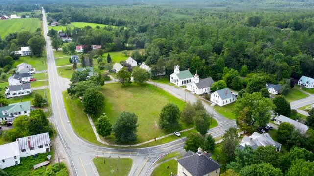Aerial cinematic video of the small New England town of Guildhall Vermont with mountains in the background.