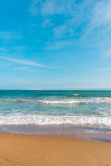 Background sea beach with waves and foam. Sandy beach and sea turquoise waves. Feeling of carelessness, enjoyment of freedom and happiness.
