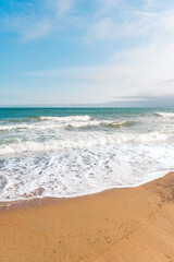 Background sea beach with waves and foam. Sandy beach and sea turquoise waves. Feeling of carelessness, enjoyment of freedom and happiness.