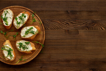Toasts with with cream cheese and micro greens peas, healthy snack. Top view
