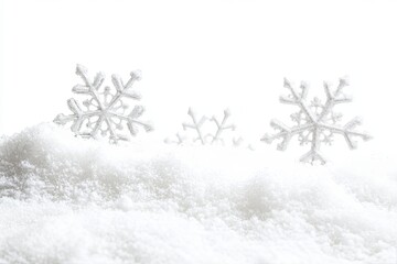 Snowflakes on a snowy drift. Soft, light, wintery scene. Background is a clean, bright white