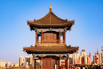 Old wall in Xian, China with traditional towers and red lanterns