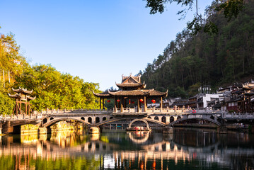 Old bridge in Fenghuang ancient town, China. Traditional chinese wooden houses in old watertown