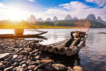 Traditional Cinese fishing boat with cormorant birds. Li river landscape, China