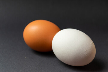 Brown and white egg - black background