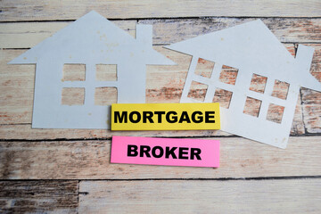 Concept of Mortgage Broker write on sticky notes isolated on Wooden Table.