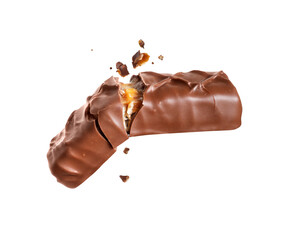 Chocolate bar with nuts crushed in the air close up isolated on a white background.