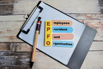 Concept of EPFO - Employees Provident Fund Organisation write on sticky notes isolated on Wooden...