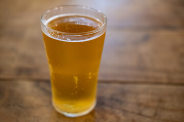 Glass of beer on the wooden table