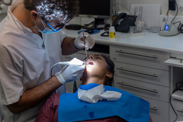 Dentist Performing a Teeth Cleaning in Modern Dental Clinic